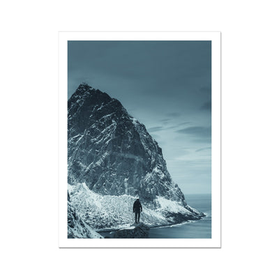 Traveler on a snowy island in the winter by the ocean Fine Art Print