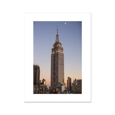 A Skyscraper in New York City at dusk with the moon in the sky Fine Art Print