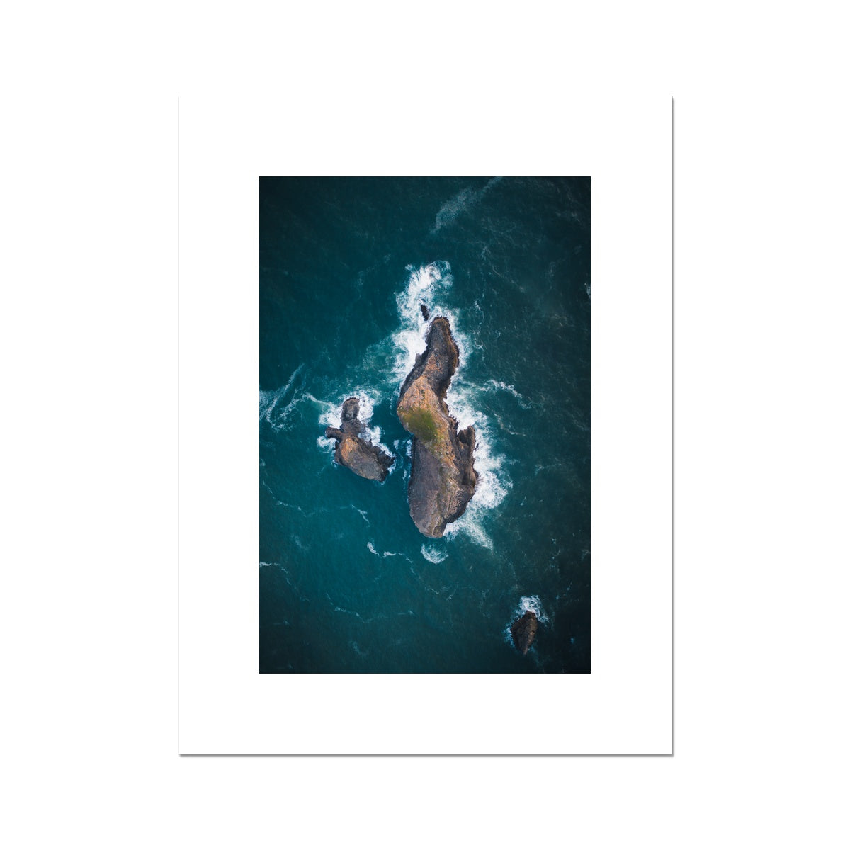 Rocky island among a deep blue ocean Fine Art Print